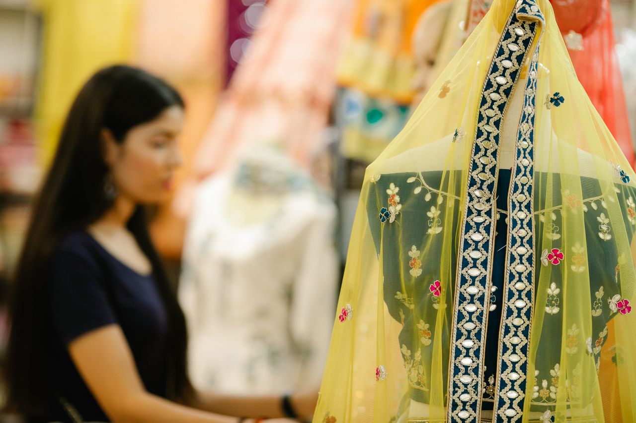 Colorful display of traditional Indian clothing in a boutique with focus on vibrant fabrics.